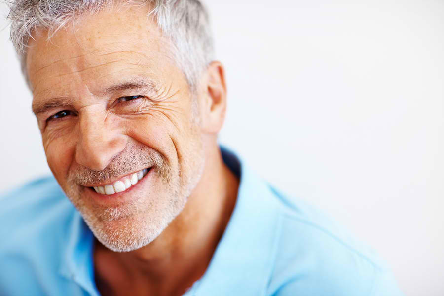 man in teal shirt smiling | belton tx dentist
