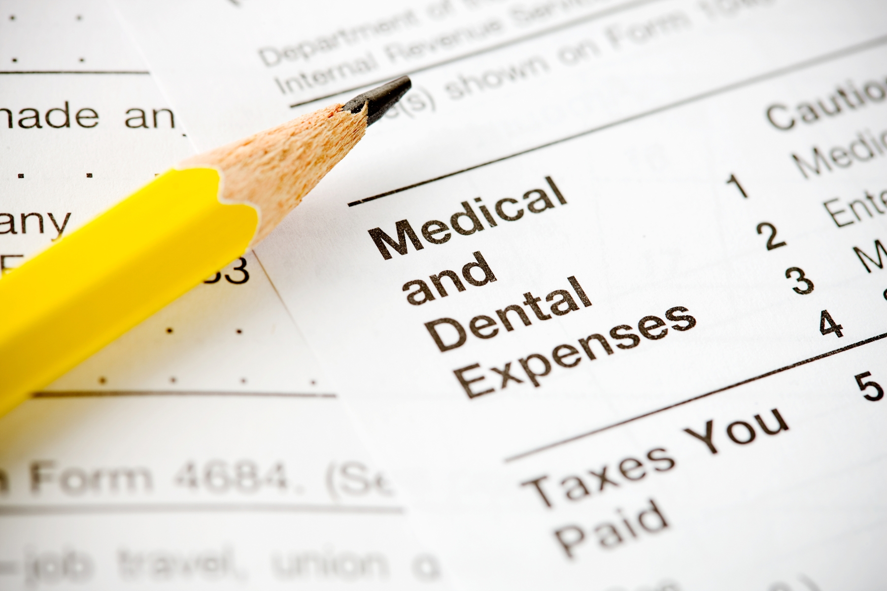 close up of dental insurance paperwork with led pencil