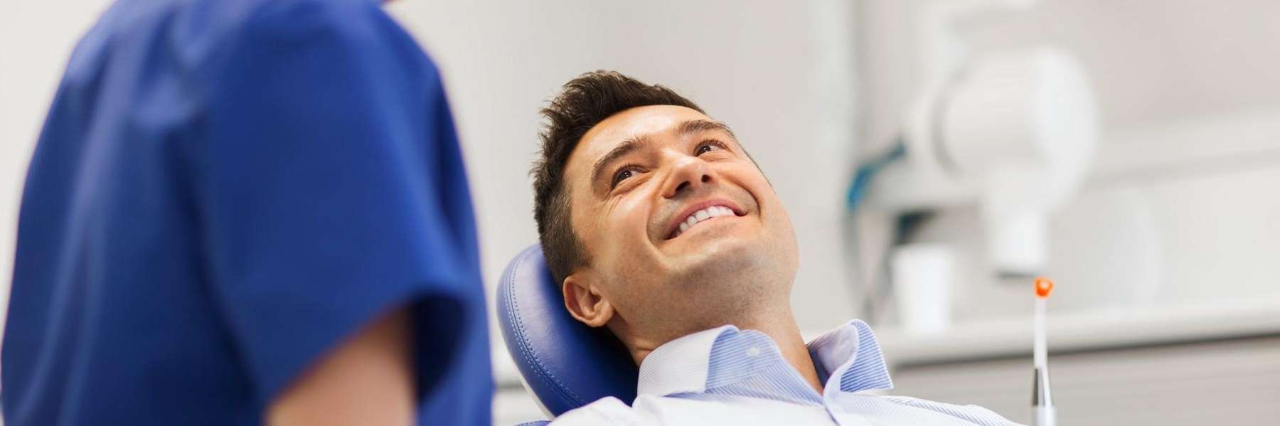 man smiling in dental exam chair | dentist temple tx