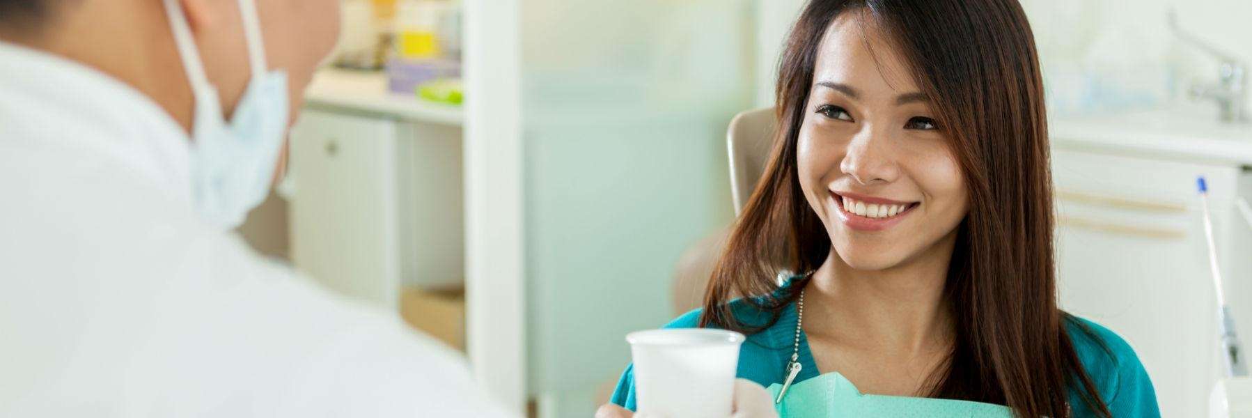 A woman smiling after a dental visit in Temple, TX